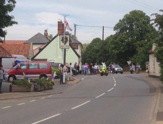 Villagers await the cyclists